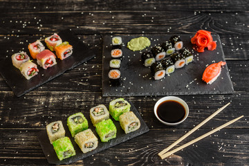 Fresh and tasty sushi on dark background. It can be used as a background