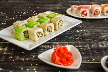 Fresh and tasty sushi on dark background. It can be used as a background