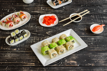 Fresh and tasty sushi on dark background. It can be used as a background