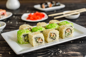 Fresh and tasty sushi on dark background. It can be used as a background
