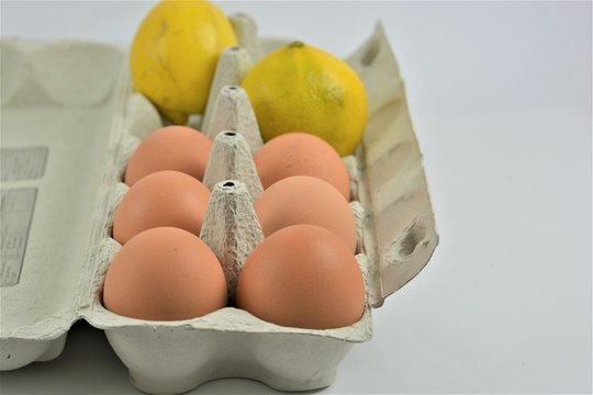 Eggs in an egg carton with lemon