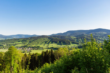 Majestic landscape of mountains and Meadow. Cycling mountain road. Misty mountain road in high mountains.. Cloudy sky with mount