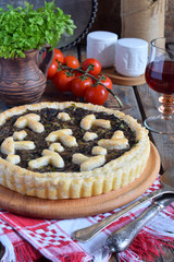 Homemade pie with mushrooms and herbs. Quiche on wooden background. Vegetarian food.