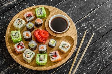 Fresh and tasty sushi on dark background. It can be used as a background