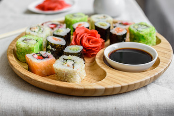 Fresh and tasty sushi on dark background. It can be used as a background
