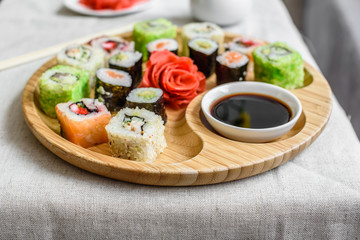 Fresh and tasty sushi on dark background. It can be used as a background