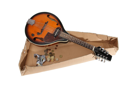 Mandolin and other things of a strolling musician on a white background