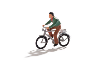 Fototapeta na wymiar Miniature man riding a bicycle