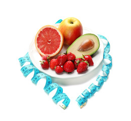 Plate with different tasty fruits and measuring tape on white background. Healthy diet