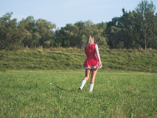 Teen Majorette Girl Twirling Baton Outdoors