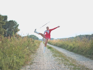 Teen Majorette Girl Twirling Baton Outdoors