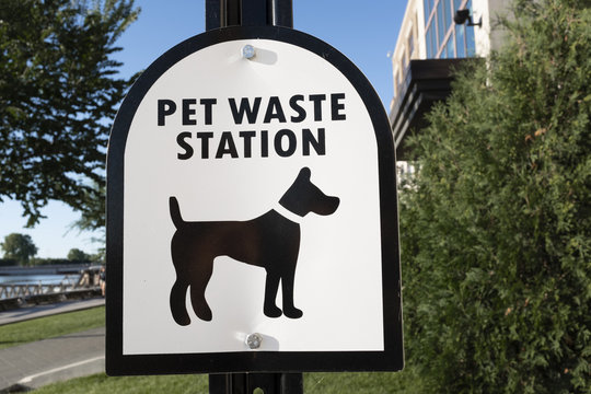 Pet Waste Station Sign On The Path And Lawn