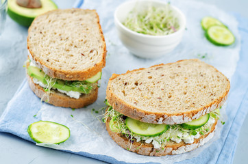 Ricotta sprouts avocado cucumber rye sandwich