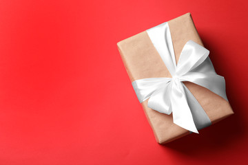 Beautiful gift box on color background, top view