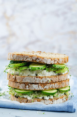 Ricotta sprouts avocado cucumber rye sandwich