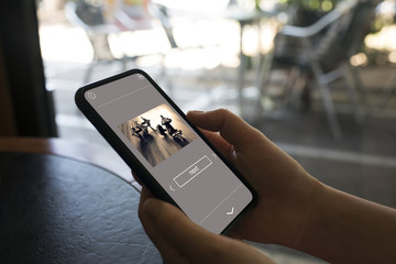 using a phone in a street cafe