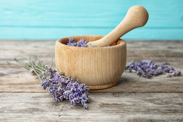 Mortar with lavender flowers on table. Ingredient for natural cosmetic
