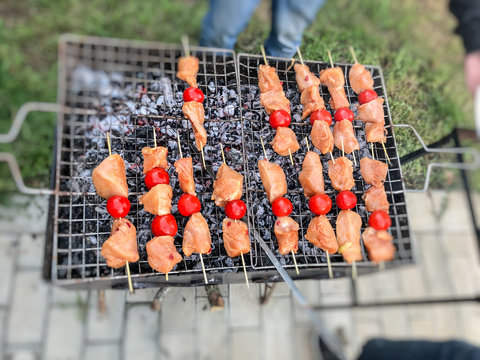 Barbecue of chicken meat with vegetables on the coals. Chicken skewers with grilled vegetables 
