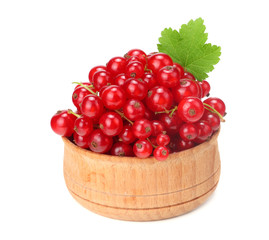 red currant in wooden bowl with green leaf isolated on white background. healthy food