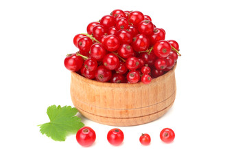 red currant in wooden bowl with green leaf isolated on white background. healthy food