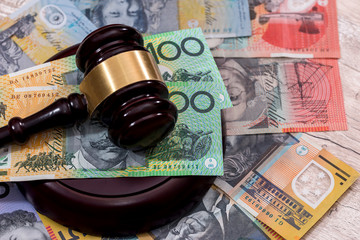 Australian dollars under judge's gavel close up
