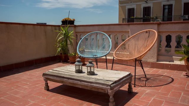 a timelapse of a cool rooftop terrace in barcelona which zooms out to reveal the surrounding city skyline