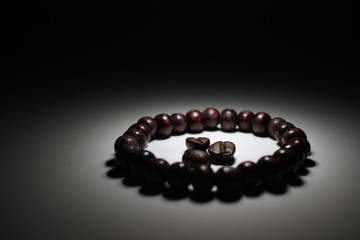 Coffee beans compassed by a bracelet of beads