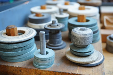 Abrasive grinding wheels on the rack are ready to work.