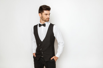 Strong commercial male model face in tuxedo on white background