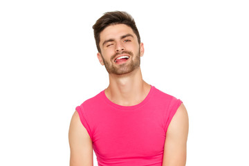 Funny emotional sexy male model in a pink t-shirt on white background