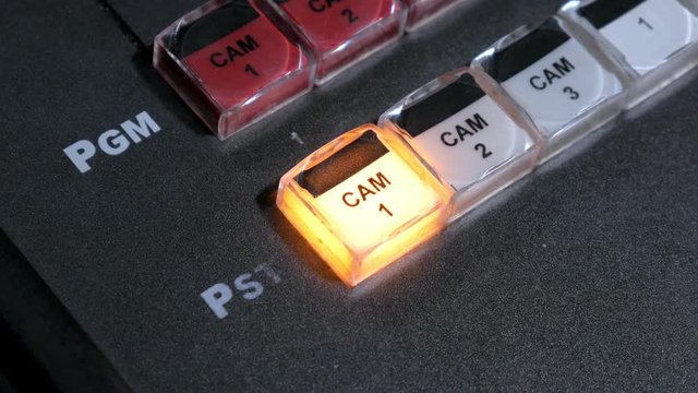hand of film director is touching key on a control panel during tv shooting