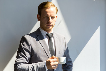Business man holding cup of coffee
