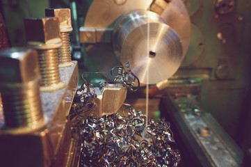 Shavings on the details close-up. Lathe, metal processing by cutting on industrial equipment....
