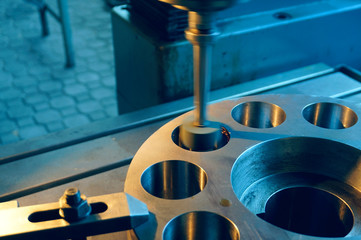 Machining of the internal hole on a coordinate grinding machine with sparks, in an industrial plant.