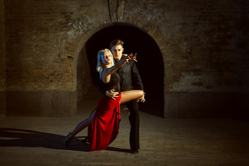 Portrait of a beautiful young couple. They dance tango.