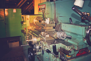 Obraz na płótnie Canvas Lathe, metal processing by cutting on industrial equipment. Tinted image.
