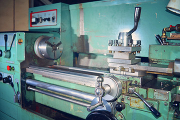 Lathe, metal processing by cutting on industrial equipment. Tinted image.