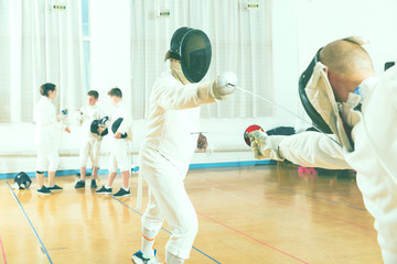 Adult fencer practicing lunge with foil