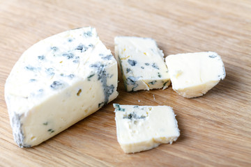 blue cheese on a wooden background with knife