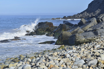 Fototapeta na wymiar Pacific Ocean waves crash, splash, and spray against the rocks on the coast of Baja California Sur, Mexico