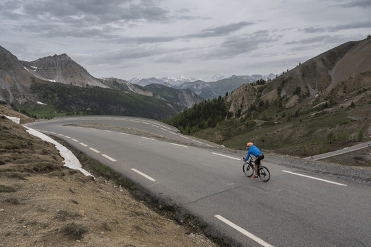 lonely man on bicycle almost at the top of col d'izoard in the alps of french haute provence