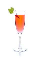 Red drink or cocktail in a glass for champagne isolated on white with red currant