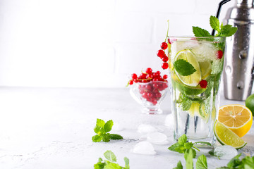 Cold summer homemade fruit and berries lemonade. Mojito, lemonade or sangria in glass. Copy space