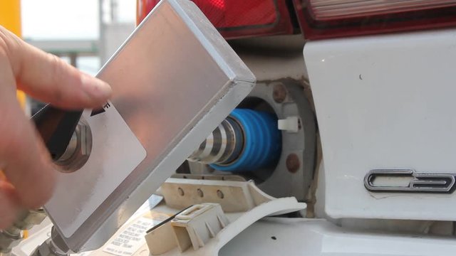 Finished filling Compressed Natural Gas (CNG) into a car. the valve is spun to off, and the gas door is closed.