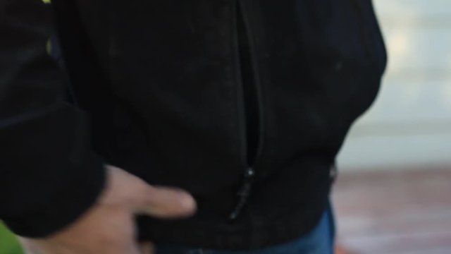 Concealed weapon in a mans waist belt is reveled.

[link]/video-sound-effects-music-after-effects-photos-illustrations-3d-models/1/clipbin:409475.html Guns and shooting collection click here.[/link]