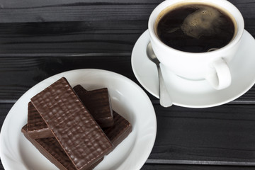 coffee with waffles in chocolate, sweets, from above