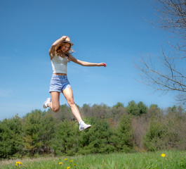 Fototapeta premium An athletic girl jumping in air.