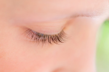 Closeup of eyelashes of young girl looking down