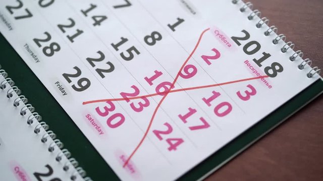 Crossing weekend dates in calendar with red pen