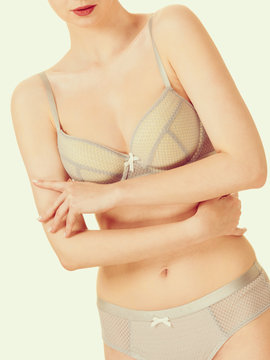 Attractive slim woman in grey matching underwear